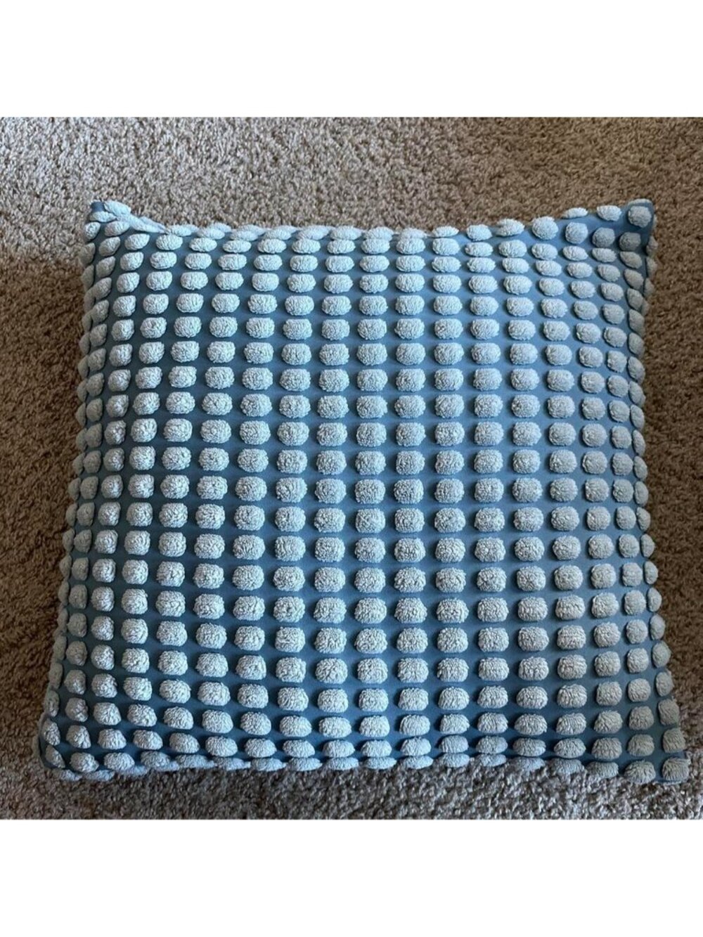 Blue pillow cover with white textured dots. Pillow not included